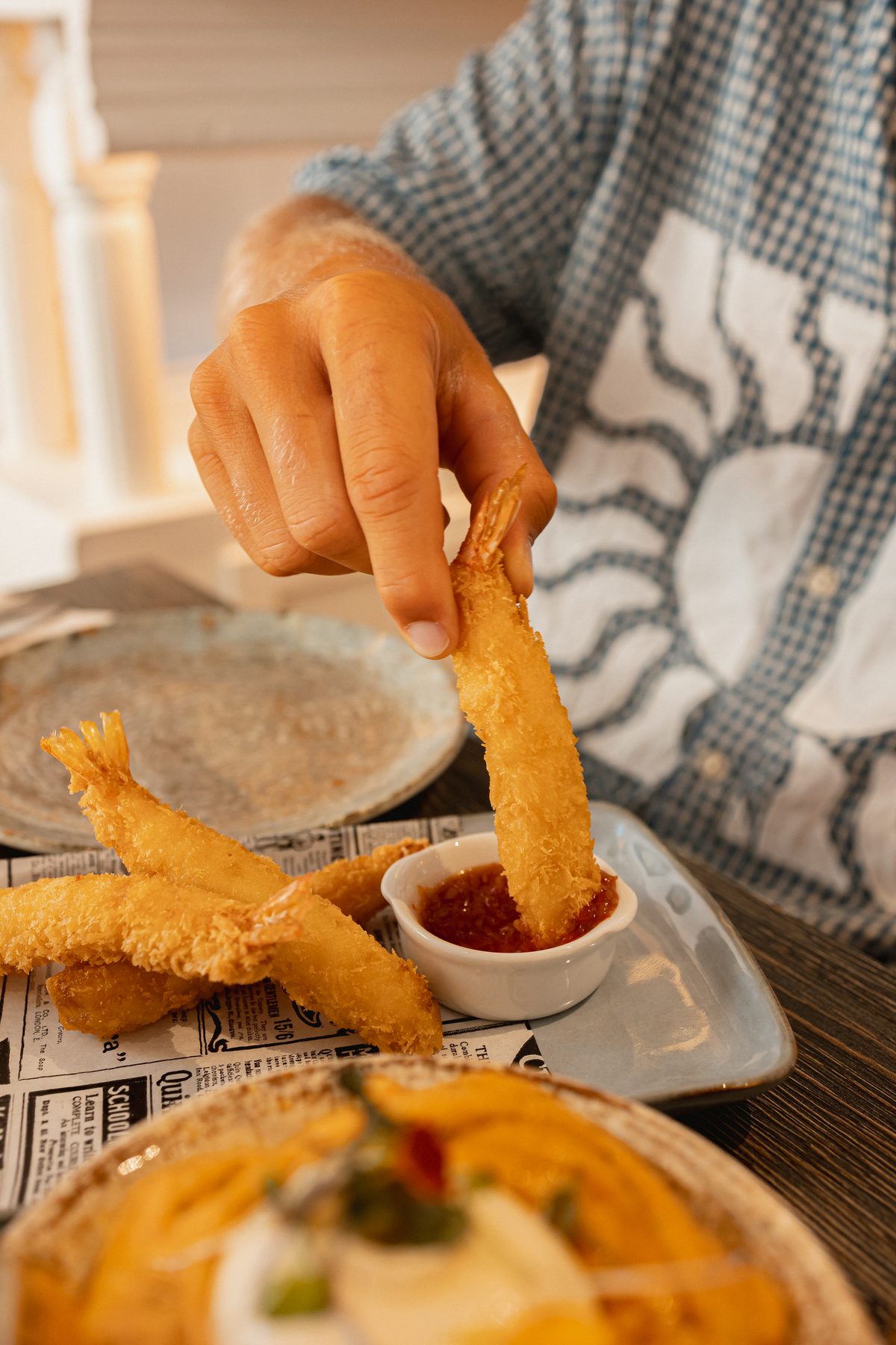 Tempura prawn dipped in sauce at Can Frasquet, Palma